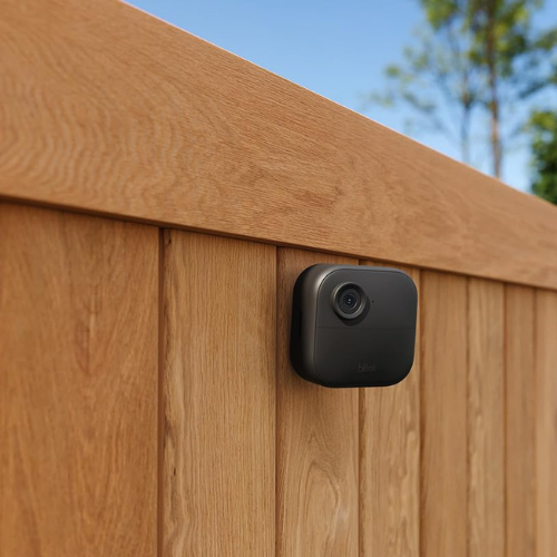 outdoor black small camera on wooden fence